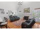 Inviting living room featuring a fireplace, hardwood floors, and ample natural light at 107 Regiment Way, Durham, NC 27705