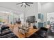 Open living space with hardwood floors, view of dining area, and bar at 107 Regiment Way, Durham, NC 27705
