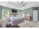 Large main bedroom with trey ceiling, a ceiling fan, two windows, and en-suite bathroom at 107 Regiment Way, Durham, NC 27705