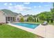 Beautiful backyard pool with patio and lounge chair, great for relaxing and enjoying sunny days at 107 Regiment Way, Durham, NC 27705