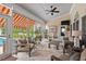 Inviting screened porch with comfortable seating, ceiling fan, and tranquil outdoor views at 107 Regiment Way, Durham, NC 27705
