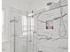 Glass shower includes elegant white and gray marble-style tile with a built-in niche at 107 Regiment Way, Durham, NC 27705