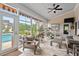 Bright sunroom with tile flooring, neutral furniture, and views of the pool and yard at 107 Regiment Way, Durham, NC 27705