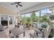 This bright sunroom offers comfortable seating and great backyard views at 107 Regiment Way, Durham, NC 27705