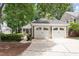Charming home featuring a detached two-car garage, complemented by lush greenery and a well-maintained driveway at 108 Ripplewater Ln, Cary, NC 27518