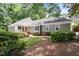 Charming home exterior with lush landscaping, a front porch, and neutral color palette nestled among mature trees at 108 Ripplewater Ln, Cary, NC 27518