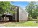 Exterior shot of a home with olive green siding, white trim, a deck, and a well-maintained lawn at 108 Ripplewater Ln, Cary, NC 27518