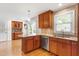 Bright kitchen featuring granite countertops, stainless steel appliances, and beautiful wood floors at 108 Ripplewater Ln, Cary, NC 27518