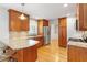 Updated kitchen featuring stainless steel appliances, granite countertops, and custom wood cabinetry at 108 Ripplewater Ln, Cary, NC 27518
