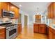 Stylish kitchen with granite countertops, stainless steel appliances, and cherry wood cabinets at 108 Ripplewater Ln, Cary, NC 27518