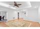 Spacious living room with hardwood floors, a decorative rug, and an adjacent kitchen area at 108 Ripplewater Ln, Cary, NC 27518