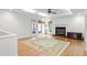 Bright living room with hardwood floors, a fireplace, large windows, and seamless access to an outdoor area at 108 Ripplewater Ln, Cary, NC 27518