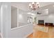 Spacious living room with hardwood floors, a fireplace, elegant chandelier, and abundant natural light at 108 Ripplewater Ln, Cary, NC 27518