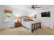 Main bedroom with ceiling fan, window and lamps at 108 Ripplewater Ln, Cary, NC 27518