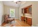 Cozy home office nook with custom wood cabinetry, countertops and window with view at 108 Ripplewater Ln, Cary, NC 27518