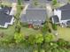 Aerial view of landscaped backyard, home exterior, and surrounding neighborhood at 109 Big Timber Path, Holly Springs, NC 27540
