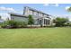 Landscaped backyard with well-maintained lawn, mature trees, and screened-in porch at 109 Big Timber Path, Holly Springs, NC 27540