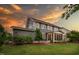 Landscaped backyard featuring a screened porch, lush green grass, and tasteful plantings, perfect for outdoor relaxation at 109 Big Timber Path, Holly Springs, NC 27540