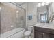 Bathroom featuring tiled shower with glass door and vanity with white countertop at 109 Big Timber Path, Holly Springs, NC 27540