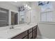 Bathroom with double sinks, large mirror, and natural light at 109 Big Timber Path, Holly Springs, NC 27540