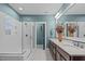 Large bathroom with double vanity and white tile shower behind glass doors at 109 Big Timber Path, Holly Springs, NC 27540