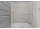 Shower/tub featuring a glass door and neutral tile at 109 Big Timber Path, Holly Springs, NC 27540