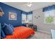 Bright bedroom featuring baseball decor, blue accent wall, and functional desk area at 109 Big Timber Path, Holly Springs, NC 27540