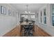Elegant dining room features wood floors, wainscoting, and views of the adjacent modern kitchen at 109 Big Timber Path, Holly Springs, NC 27540