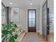 Bright entryway with hardwood floors and a stylish glass-paneled door at 109 Big Timber Path, Holly Springs, NC 27540