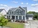 Beautiful two-story home with a detached garage and a well-manicured lawn at 109 Big Timber Path, Holly Springs, NC 27540