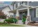 Inviting front porch with stone pillars and carefully placed landscaping, leading to an elegant front door at 109 Big Timber Path, Holly Springs, NC 27540
