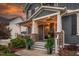 Charming front porch with stone accents, decorative plants, and a well-maintained walkway to the front door at 109 Big Timber Path, Holly Springs, NC 27540