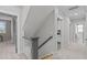 Hallway with carpet and stairway, next to doorway to other rooms and white walls at 109 Big Timber Path, Holly Springs, NC 27540