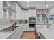 Bright kitchen with stainless appliances, a marble backsplash, and marble countertops for a modern look at 109 Big Timber Path, Holly Springs, NC 27540
