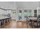 Bright, open-concept kitchen with white cabinetry, large island, and stainless steel appliances at 109 Big Timber Path, Holly Springs, NC 27540
