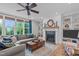 Inviting living room features fireplace, built-in shelves, and large windows for plenty of natural light at 109 Big Timber Path, Holly Springs, NC 27540