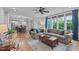 Open-concept living room with stylish decor and hardwood floors, flowing seamlessly into the kitchen at 109 Big Timber Path, Holly Springs, NC 27540