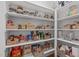 Organized walk-in pantry offers ample storage with shelves and baskets for easy access to food items at 109 Big Timber Path, Holly Springs, NC 27540
