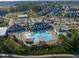 Aerial view of a large community pool with clubhouse, ample seating, and parking at 109 Big Timber Path, Holly Springs, NC 27540