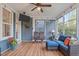 Cozy sunroom with comfortable furniture, wood-look floors, and large windows providing natural light at 109 Big Timber Path, Holly Springs, NC 27540