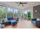 Relaxing sunroom boasts floor-to-ceiling windows, a vaulted ceiling, and comfortable seating with backyard views at 109 Big Timber Path, Holly Springs, NC 27540