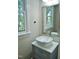 Bathroom features a vessel sink, framed mirror, and a large window at 1104 Barrow Nook Ct, Apex, NC 27502