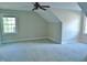 Carpeted bedroom featuring neutral walls and natural light streaming in through two windows and a ceiling fan at 1104 Barrow Nook Ct, Apex, NC 27502
