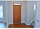 Entryway featuring a wooden door, hardwood floors, and staircase at 1104 Barrow Nook Ct, Apex, NC 27502