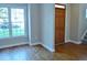 Spacious entryway featuring a wooden door, hardwood floors, and a large window at 1104 Barrow Nook Ct, Apex, NC 27502