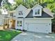 Charming two-story home featuring a covered porch, a two-car garage, and a driveway at 1104 Barrow Nook Ct, Apex, NC 27502