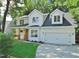 Charming two-story home featuring a covered porch, a two-car garage, and a driveway at 1104 Barrow Nook Ct, Apex, NC 27502