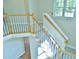 Hallway overlooking the entry featuring a wooden handrail, neutral walls and carpet, and natural light from the windows at 1104 Barrow Nook Ct, Apex, NC 27502