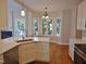 Bright, open kitchen with white cabinets, quartz countertops, and a dining area at 1104 Barrow Nook Ct, Apex, NC 27502
