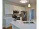 Well-equipped kitchen with stainless appliances, white cabinetry, and quartz counters at 1104 Barrow Nook Ct, Apex, NC 27502